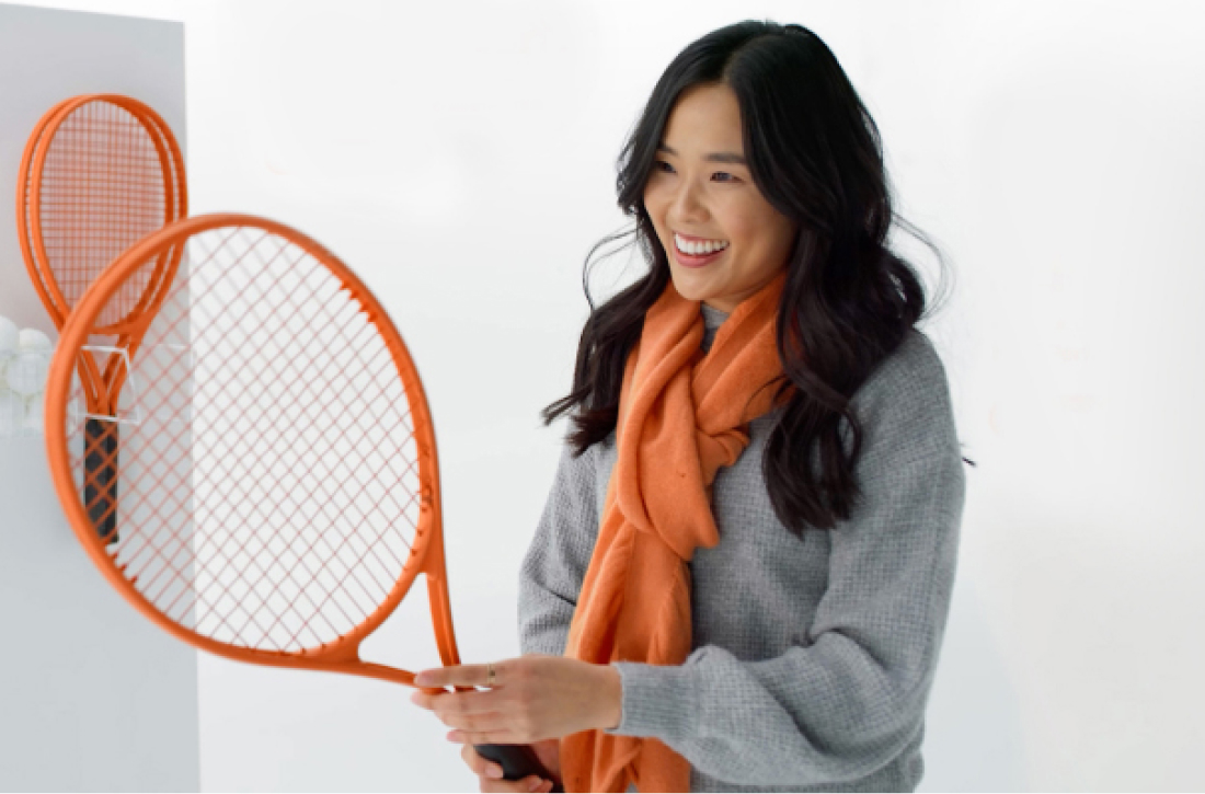 Woman holding tennis racquet.